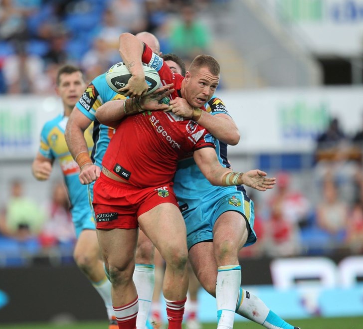 Photo by Colin Whelan copyright © nrlphotos.com :       Trent Merrin looks to unload as he is grabbed by Luke Douglas                        NRL Rugby League, Round 15 Gold Coast Titans v St George Illawarra Dragons at Robina, Sunday June 22nd 2014.