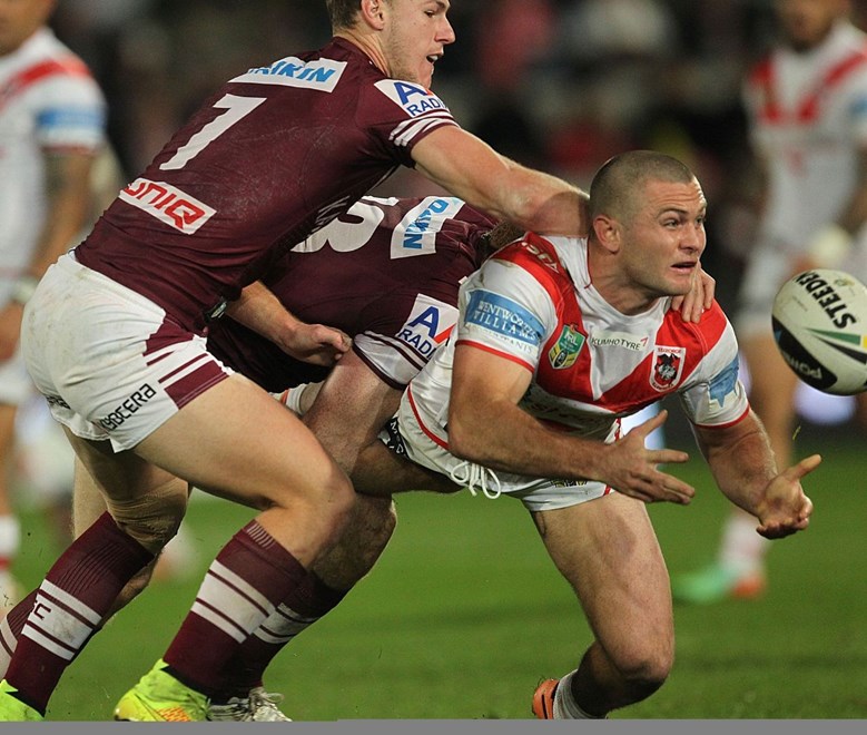 .Photo by Colin Whelan copyright © nrlphotos.com :     Mitch Rein offloads as he is grabbed by Daly Cherry-Evans                          NRL Rugby League, Round 19 St George Illawarra Dragons v Manly Warringah Sea Eagles at Win Jubilee, Monday July 21st 2014.