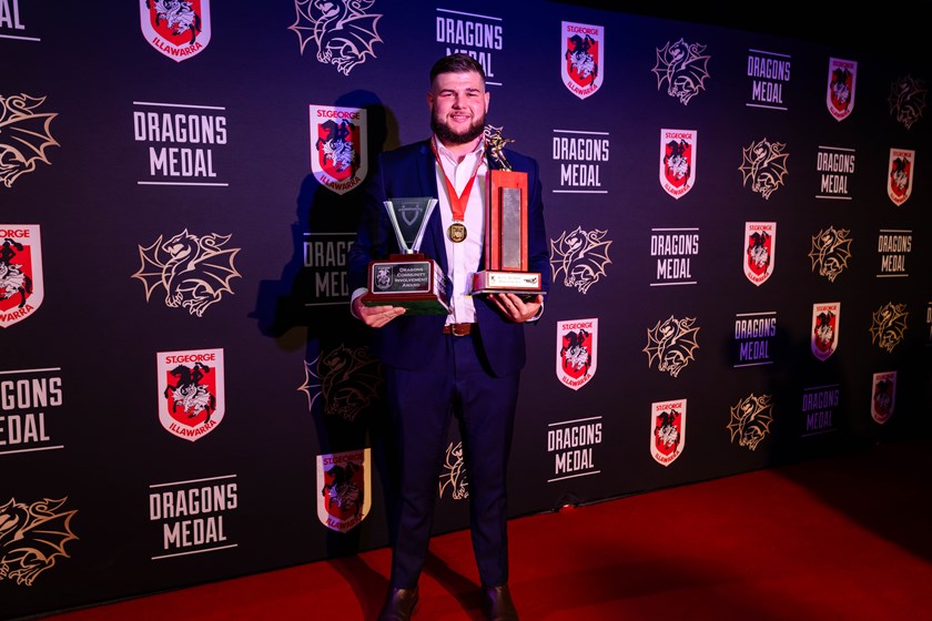 Blake Lawrie photographed with the Dragons Medal, the Red V Members Player of the Year Award, and the Community Involvement Award.
