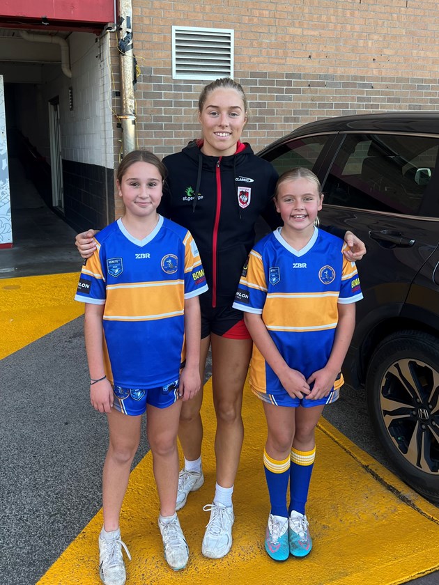 Teagan Berry takes pictures with the Bomaderry Swamprats under-10s league tag girls.