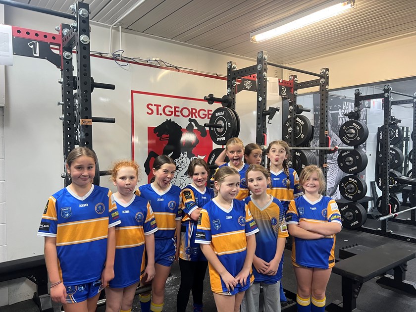 The Bomaderry Swamprats under-10s league tag girls pose in the gym at WIN Stadium.