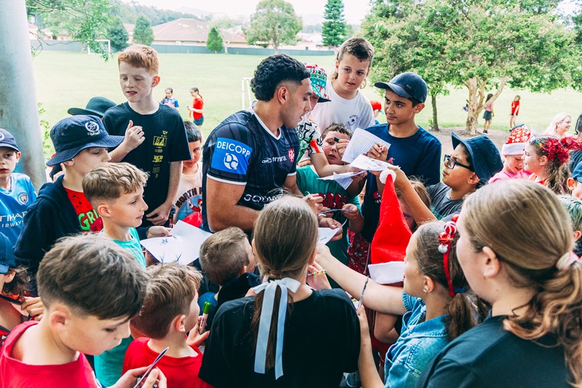 Hometown Dragons' hero Tyrell Sloan is mobbed during the signing session.