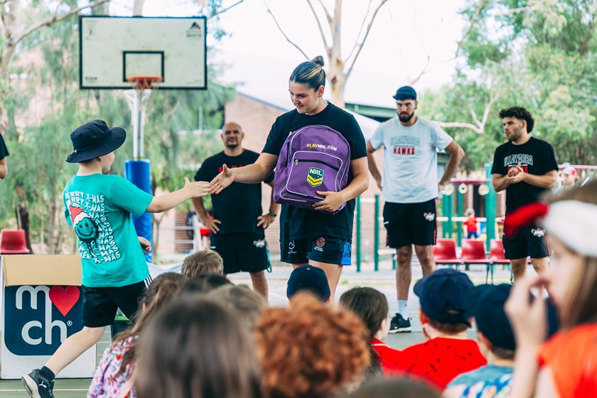 Dragons' NRLW star Bobbi Law presenting prizes to some hardworking students.