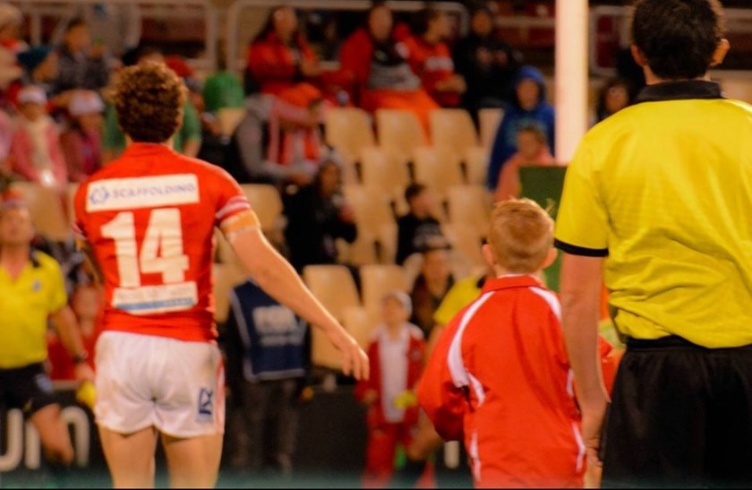 A young Reed in his ballboy attire at WIN Stadium.