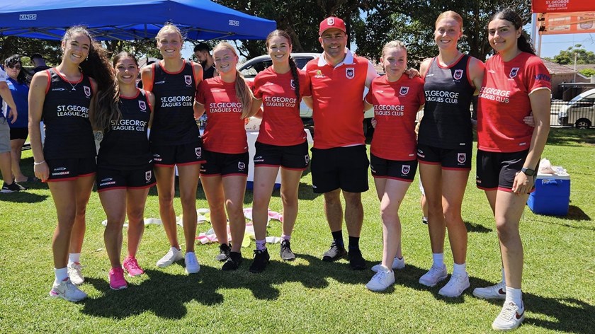NRLW head coach Jamie Soward pictured with some young Dragons stars.