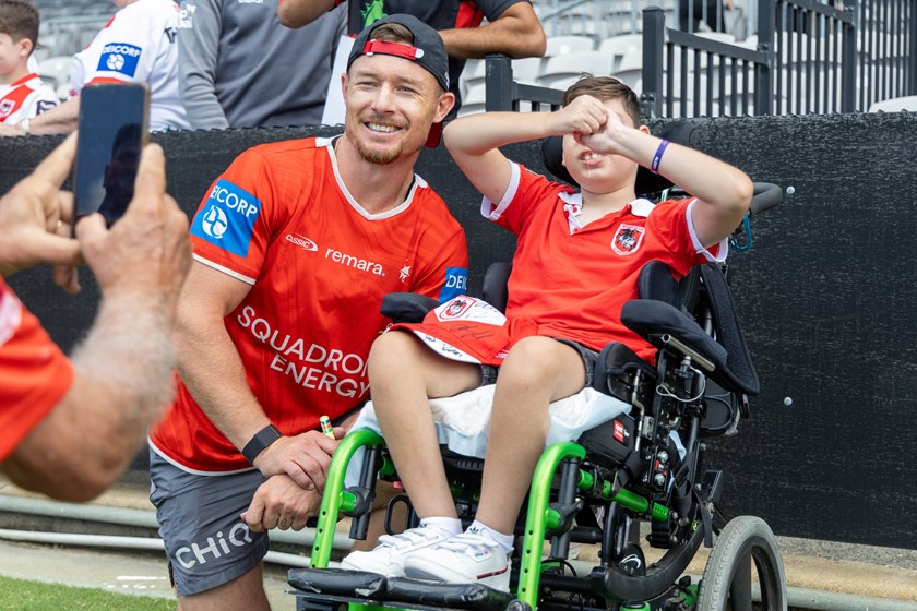 Co-captain Damien Cook spends time with a young fan.