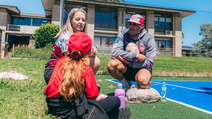 Tyrell Sloan listens to a student at his former school.