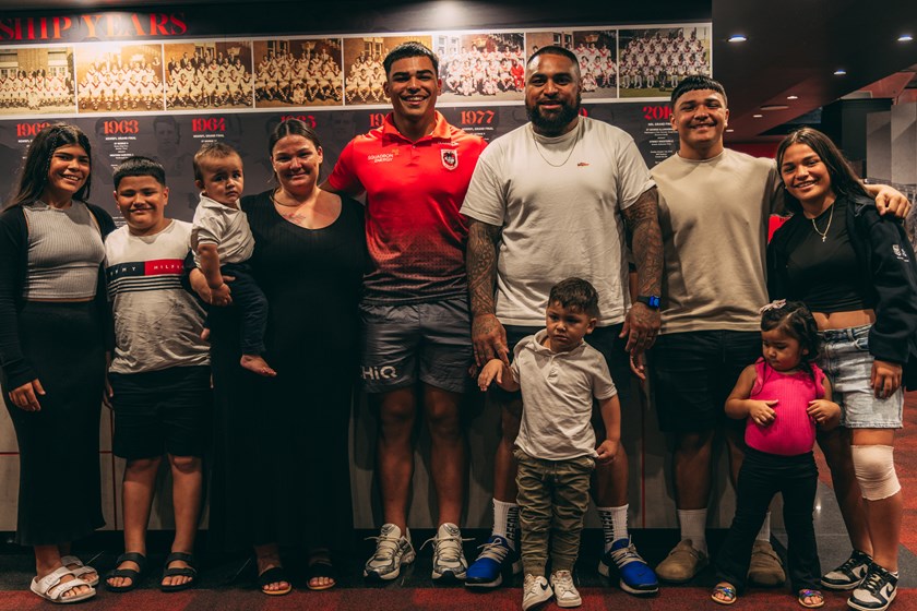 Halangahu photographed with his parents and seven younger siblings after signing his contract extension.