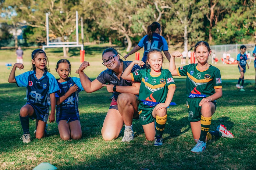 Dragons NRLW star Madi Mulhall poses with some juniors from Riverwood Legion & Penshurst RSL.